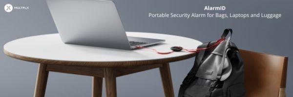 Image shows an AlarmID attached to a computer at a table. 