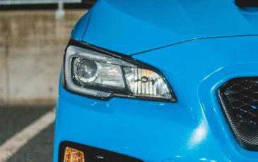 A parked blue car. 