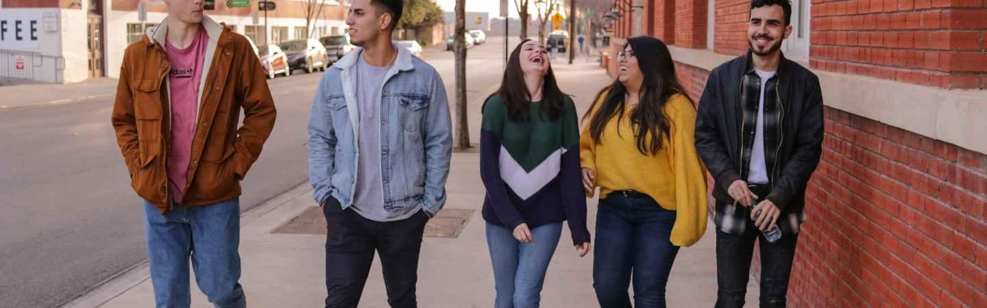 Young people walking in a street together, posed photo