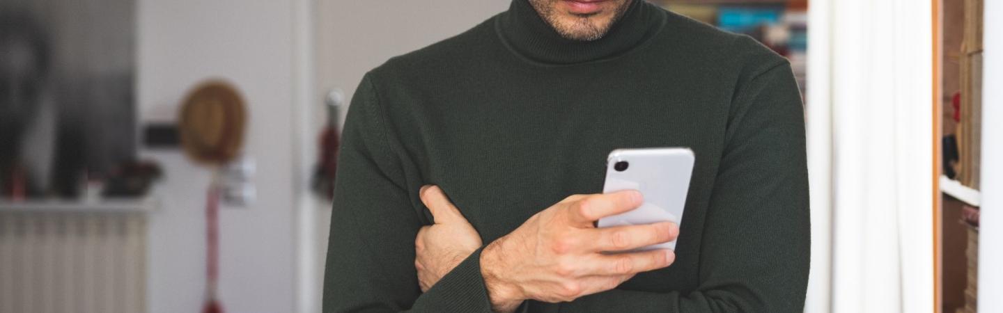 Image shows a concerned man holding a phone