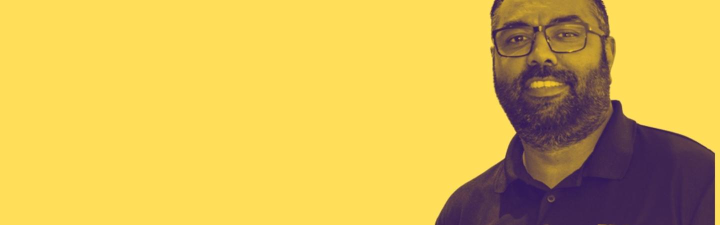 Image shows a picture of Sumier Foster Shah - he's smiling, he has dark hair and a beard and is wearing an ERA shirt 