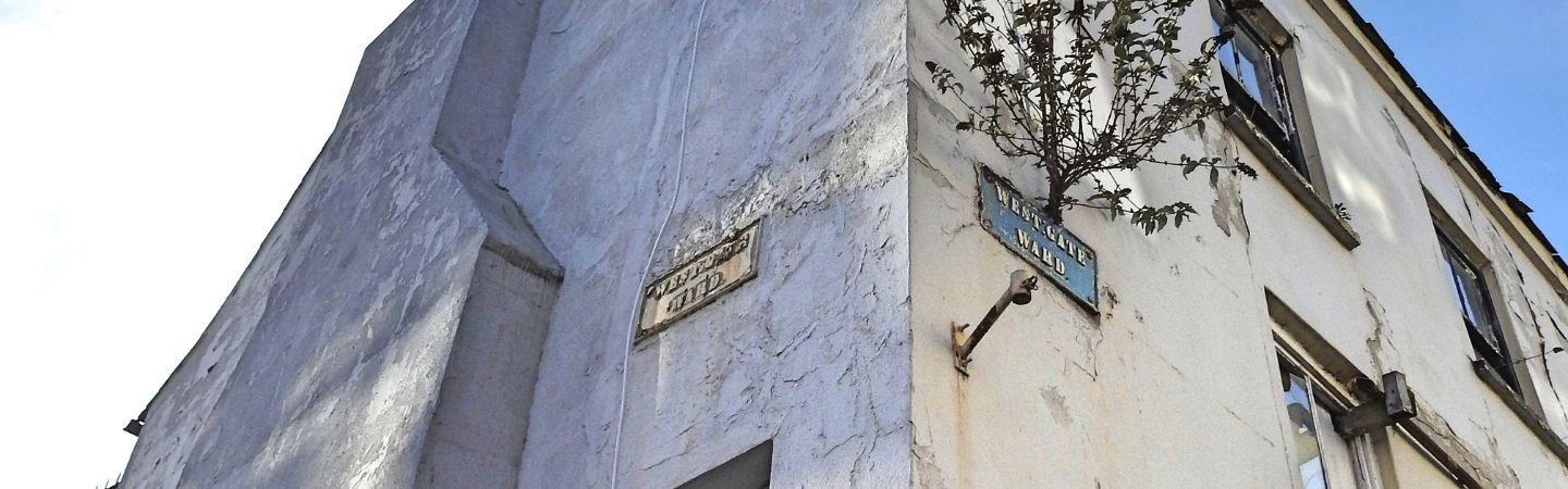 The corner of a derelict building. 